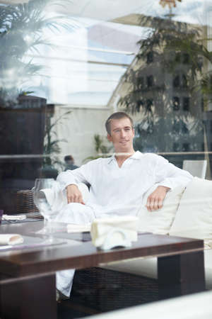 Attractive young man in a restaurantの写真素材