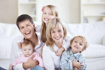 Parents and three children at homeの写真素材
