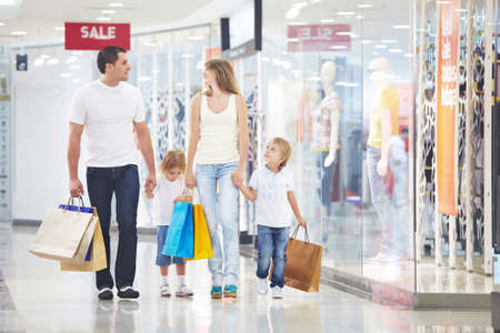 A happy family is shopping in a storeの写真素材
