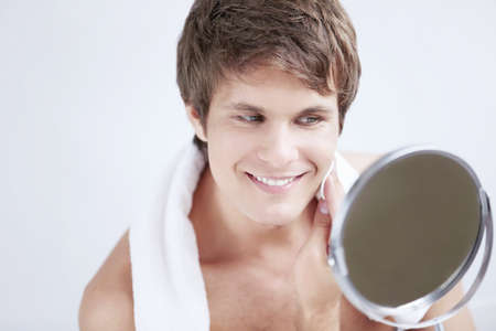 The man rubs the face with cotton padの写真素材