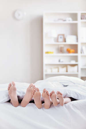 Heels sticking out from under the blanket in the apartment