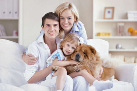 Family with pets at homeの写真素材