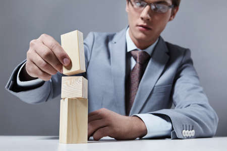 A young businessman is building design on a gray backgroundの写真素材