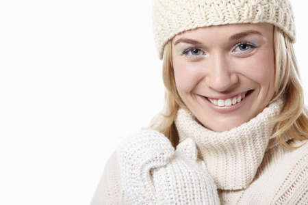 Woman in hat and mittens on a white backgroundの写真素材