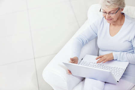 Mature woman working with laptopの写真素材