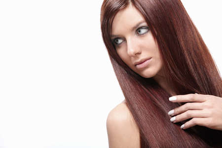 Attractive young girl with beautiful hair on a white backgroundの写真素材
