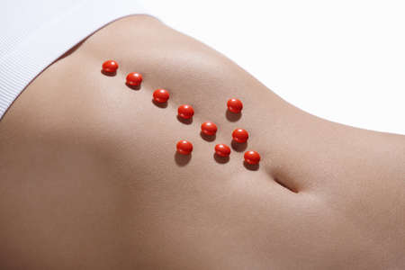 The red arrow on the abdomen of a young girlの写真素材