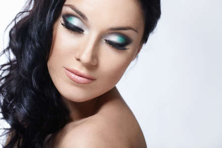 Beautiful girl with make-up with closed eyes on a white backgroundの写真素材