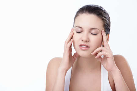 Young attractive girl suffers a headacheの写真素材