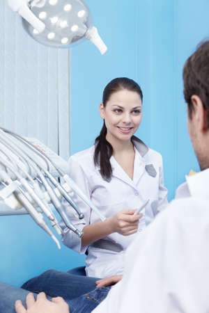 A young dentist accepts patientsの写真素材