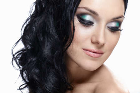 Young beautiful girl with makeup on white backgroundの写真素材