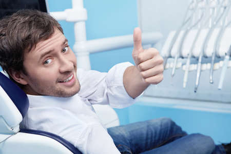 A young man in a dental chairの写真素材