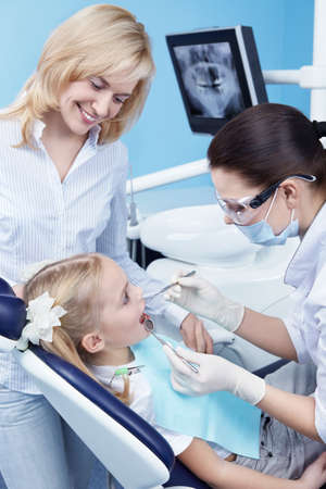 Child treated teeth in the dental clinicの写真素材
