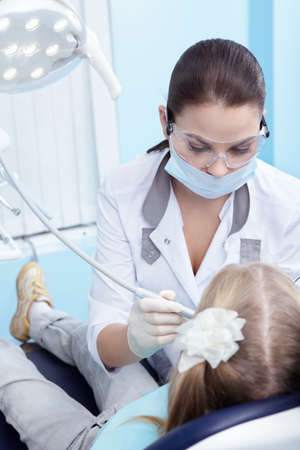 The doctor treating your child's teeth in the dental clinicの写真素材