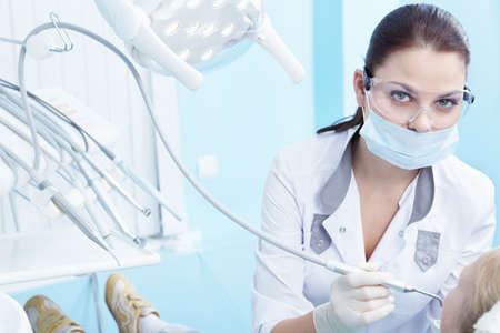 The doctor treating your child's teeth in the dental clinicの写真素材