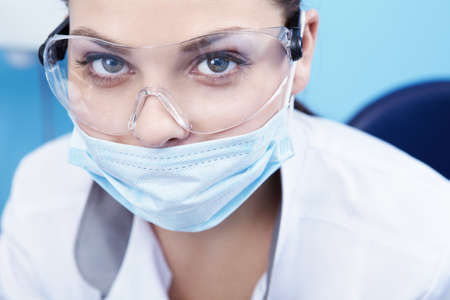 Doctor in a mask and goggles close-upの写真素材