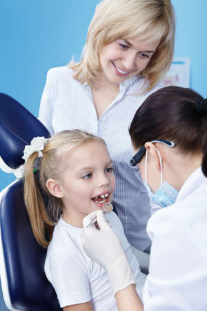 The dentist makes examination of the childの写真素材