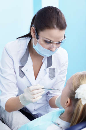 The dentist examines a child in dentistryの写真素材