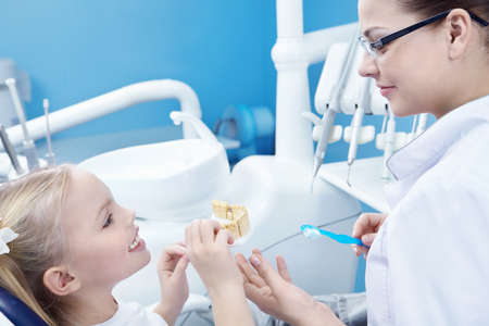 The dentist and child in the dental officeの写真素材