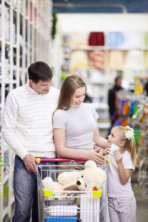 A young family is shopping in a storeの写真素材