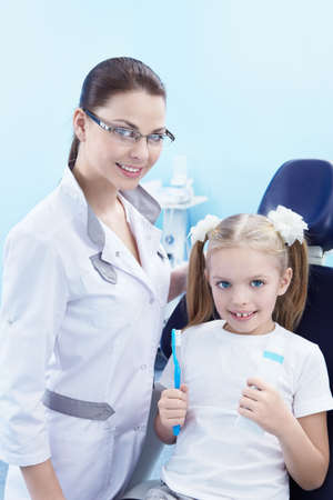 Dentist with a child in the dental clinicの写真素材