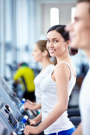 Young attractive people in the fitness club
