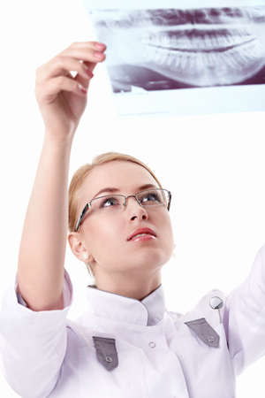 X-ray of a attractive nurse looks on a white backgroundの写真素材