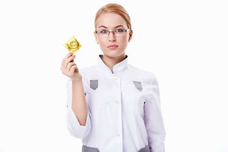 A young doctor with a condom on a white backgroundの写真素材