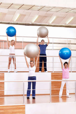 Young people are engaged in aerobic exercise with ballsの写真素材