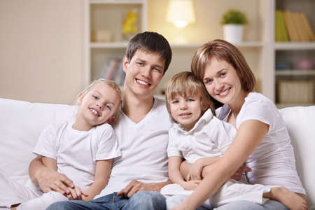 A happy family with children at home in the eveningの写真素材