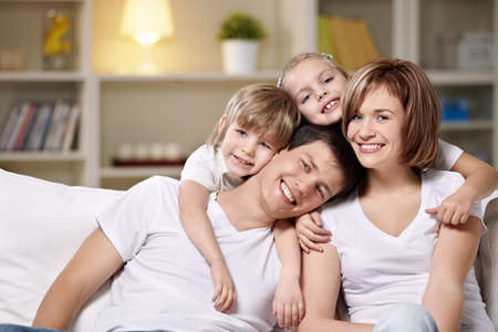 Laughing families with children at home in the eveningの写真素材