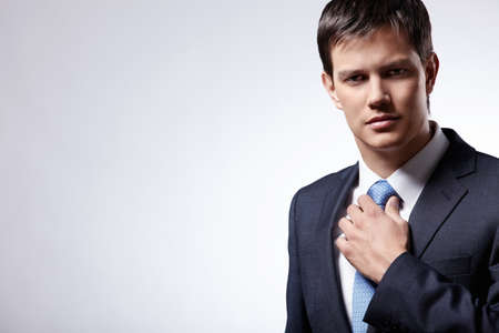 Attractive businessman in a business suit with a gray backgroundの写真素材