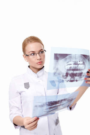The young doctor examines an x-ray on a white background