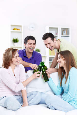 Young friends drinking beerの写真素材