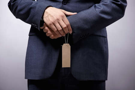 A man in a suit with a tagの写真素材