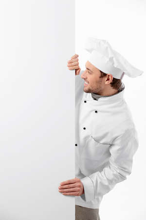 Cook looks to an empty board on a white backgroundの写真素材