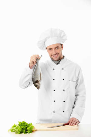 A cook prepares food on a white backgroundの写真素材