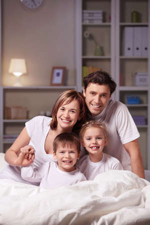 Parents with children at home in the eveningの写真素材