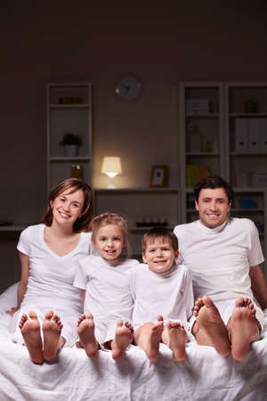A happy family evening in the bedroomの写真素材