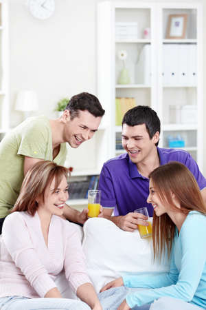Smiling young friends at homeの写真素材