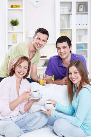 Attractive young friends at homeの写真素材