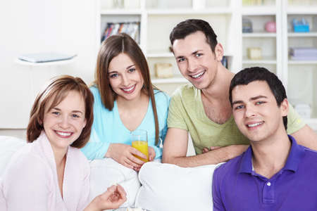 Attractive smiling friends at homeの写真素材