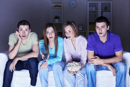 Surprised people are watching a movieの写真素材