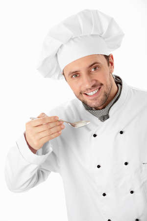 Attractive cook with spoon on white backgroundの写真素材