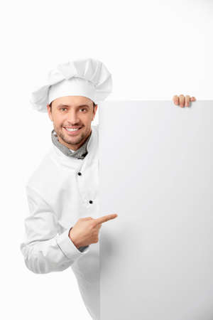 Attractive cook shows on a white backgroundの写真素材