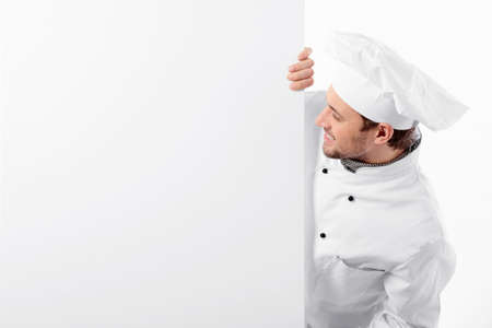 Attractive cook looks at a blank white backgroundの写真素材