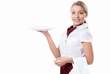 A young waitress with an empty plate on a white backgroundの写真素材
