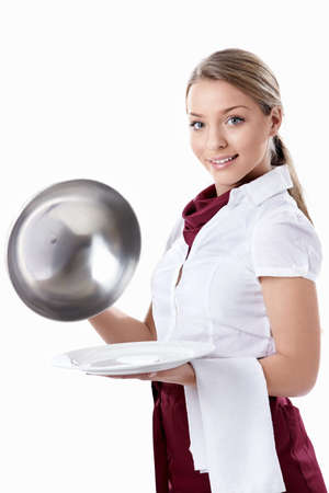 A young waitress with an empty plate and a dome on a white backgroundの写真素材