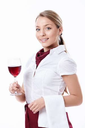 A young waitress with a glass of wine on a white backgroundの写真素材