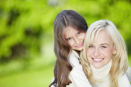 Happy mother and daughter outdoorsの写真素材